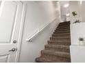 Carpeted staircase leading upstairs, complemented by fresh white walls, trim, and natural light at 11260 N 92Nd St # 2023, Scottsdale, AZ 85260