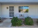 Inviting front porch featuring charming decor and well-maintained landscaping at 13807 N Garden Ct Dr, Sun City, AZ 85351