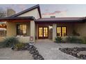 Inviting front entrance featuring a decorative walkway, red framed windows, and desert landscaping at 1422 E Royal Palm Rd, Phoenix, AZ 85020