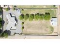 Aerial view of a large property with a main house, guest house, large lawn, mature trees, and ample parking at 15218 E San Tan Blvd, Gilbert, AZ 85298