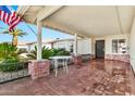 Inviting front porch with brick columns, wrought iron railings, and a decorative table, perfect for relaxation at 1684 Leisure World --, Mesa, AZ 85206