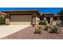 Single-story home featuring desert landscaping, a two-car garage, and a welcoming entrance at 16902 W Marcos De Niza Dr, Surprise, AZ 85387