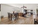 Open-concept living space with hardwood floors, a dining area, and seamless flow to the kitchen at 1705 W Stephanie Ln, San Tan Valley, AZ 85144