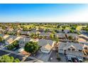 Expansive aerial view of a residential neighborhood, golf course, and mountain backdrop on a bright sunny day at 1750 N Abner --, Mesa, AZ 85205