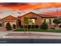 Charming single-story brick home featuring a well-manicured lawn and beautiful desert landscaping at 21647 S 223Rd Pl, Queen Creek, AZ 85142