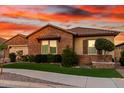 Charming single-story brick home featuring a well-manicured lawn and beautiful desert landscaping at 21647 S 223Rd Pl, Queen Creek, AZ 85142