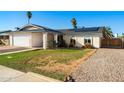 Attractive single-story house with a well-maintained lawn and desert landscaping at 2962 E Dolphin Ave, Mesa, AZ 85204