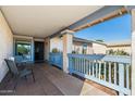 Inviting covered front porch with seating area, showcasing the home's entry and charming details at 2962 E Dolphin Ave, Mesa, AZ 85204