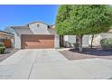 Single-story home boasts a neatly landscaped front yard and a two-car garage, blending comfort with outdoor charm at 29674 N 127Th Ln, Peoria, AZ 85383