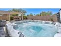 Beautiful hot tub with desert landscaping offers a relaxing outdoor retreat and al fresco experience at 29674 N 127Th Ln, Peoria, AZ 85383