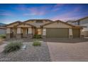 Beautiful single-Gathering home with a three car garage, desert landscaping, and a brick paver driveway at 3005 W Donatello Dr, Phoenix, AZ 85086
