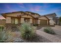 Beautiful single-Gathering home with a three car garage, desert landscaping, and a brick paver driveway at 3005 W Donatello Dr, Phoenix, AZ 85086
