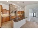 Modern kitchen featuring a granite island, stainless steel appliances, and a decorative stone hood at 3005 W Donatello Dr, Phoenix, AZ 85086