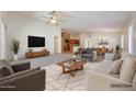 Bright open-concept living room with ceiling fan, stylish furnishings, and seamless flow to dining area at 3005 W Donatello Dr, Phoenix, AZ 85086