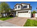 Two-story home featuring a brick driveway, two car garage, and lush lawn on a sunny day at 3028 E Austin Dr, Gilbert, AZ 85296