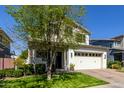 Charming two-story home with lush green lawn, mature tree, and classic architectural design at 3028 E Austin Dr, Gilbert, AZ 85296