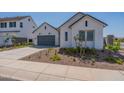 Beautiful white single-story home featuring a gray garage door and landscaped front yard at 35658 N Lodestone Dr, San Tan Valley, AZ 85144