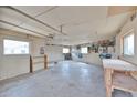 The unfinished garage interior shows potential for a workshop or storage space with natural light at 3642 W Belmont Ave, Phoenix, AZ 85051