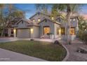 Charming two-story home showcasing lush green lawn, mature trees, and a welcoming entrance at 4325 E Vallejo Ct, Gilbert, AZ 85298