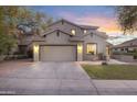 Inviting exterior showcasing a spacious driveway and well-maintained lawn, blending functionality with charm at 4325 E Vallejo Ct, Gilbert, AZ 85298