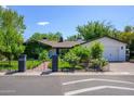 Charming home with black iron fence and gate and detached garage at 4331 E Avalon Dr, Phoenix, AZ 85018