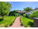 Charming home featuring lush greenery and a welcoming brick walkway at 4331 E Avalon Dr, Phoenix, AZ 85018