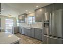 Kitchen featuring stainless steel appliances, white countertops, gray cabinets, and wood-look flooring at 5800 W Kesler St, Chandler, AZ 85226