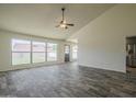 Living room featuring wood-look tile flooring, vaulted ceilings, and lots of natural light at 5800 W Kesler St, Chandler, AZ 85226