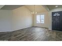 Spacious living room with a chandelier, light walls, and luxury vinyl flooring at 5800 W Kesler St, Chandler, AZ 85226