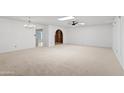 Spacious living room featuring neutral carpeting and arched doorway at 6105 N 12Th Way, Phoenix, AZ 85014