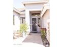 Inviting front entrance with desert landscaping and a decorative security screen door at 7024 W Tether Trl, Peoria, AZ 85383