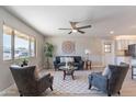 Cozy living room featuring neutral tones, stylish furniture, and a ceiling fan for comfortable living at 7526 E Mckinley St, Scottsdale, AZ 85257