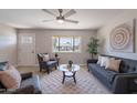Inviting living room with cozy seating, natural light, ceiling fan, and stylish decor at 7526 E Mckinley St, Scottsdale, AZ 85257