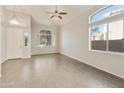 Bright living room featuring modern light fixtures, tile flooring, and arched windows at 770 W Kent Pl, Chandler, AZ 85225