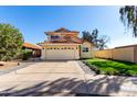 Charming two-story home with a red tile roof, a spacious driveway, and well-maintained landscaping at 8807 E Dahlia Dr, Scottsdale, AZ 85260