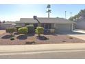 Charming single-story home with a well-maintained lawn, desert landscaping, and a two-car garage at 9003 W Griswold Rd, Peoria, AZ 85345