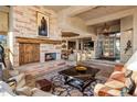 Spacious living room with a stone fireplace, coffered ceilings, and an open layout at 9920 E Honey Mesquite Dr # 155, Scottsdale, AZ 85262
