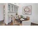 Bright dining area featuring a round table, built-in cabinets, and a stylish decor that compliments the space at 10290 N 117Th Pl, Scottsdale, AZ 85259
