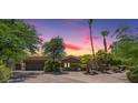 Charming single-story home boasts lush landscaping, mature trees, and a stone facade, offering exceptional curb appeal at 10290 N 117Th Pl, Scottsdale, AZ 85259