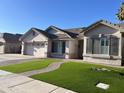 Street view of a single-story home with a manicured front lawn and a brick-paved walkway at 1444 W Spruce Dr, Chandler, AZ 85286