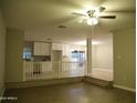 Open living room showcasing wood floors and seamless flow to the kitchen with white cabinets at 2215 W Highland Ave, Phoenix, AZ 85015