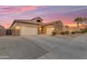 Spacious home boasting three-car garage, stone accents, and well-maintained landscaping at dusk at 22186 E Via Del Verde --, Queen Creek, AZ 85142