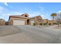 Spacious home featuring a three-car garage, desert landscaping, and well-maintained exterior at 22186 E Via Del Verde --, Queen Creek, AZ 85142