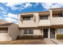 Townhome exterior featuring beige stucco, multiple windows, and a well-maintained front yard at 2221 W Farmdale Ave # 7, Mesa, AZ 85202