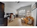 Home office features hardwood floors, a chaise lounge, a desk, and shuttered windows at 2414 W White Feather Ln, Phoenix, AZ 85085