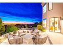 Outdoor patio at dusk with comfortable seating and scenic views overlooking the valley at 24350 N Whispering Ridge Way # 22, Scottsdale, AZ 85255