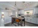 Open kitchen design with white cabinets, granite countertops, stainless steel appliances, and island seating at 2889 S 161St Dr, Goodyear, AZ 85338