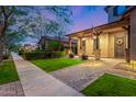 Inviting home exterior with covered porch, lovely landscaping, and walkway at 2950 E Los Altos Ct, Gilbert, AZ 85297