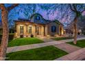 Charming exterior showcasing a covered porch, well-kept lawn, and inviting entrance at 2950 E Los Altos Ct, Gilbert, AZ 85297