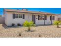 Charming single-story home featuring desert landscaping, covered entryway, and dark shuttered windows at 3249 E Nisbet Rd, Phoenix, AZ 85032